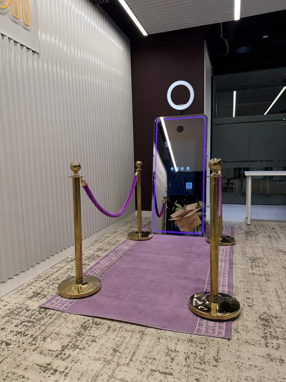 Magic Mirror photo booth with a purple carpet and stanchions